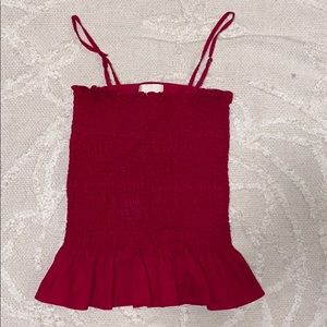 Red tank top. Rouched look with flared bottom.